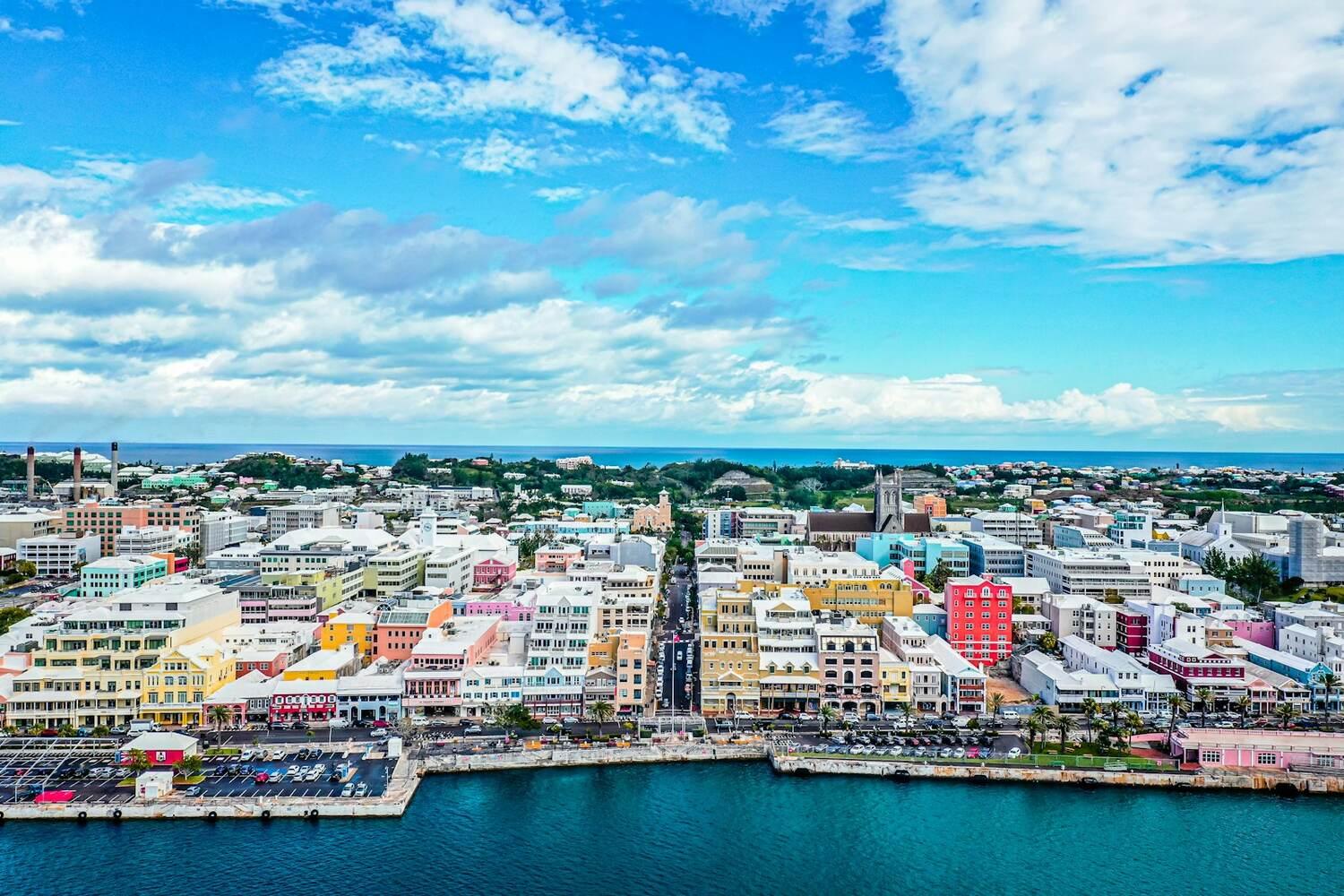 Colourful buildings and a harbour in Hamilton, Bermuda, under a blue sky
