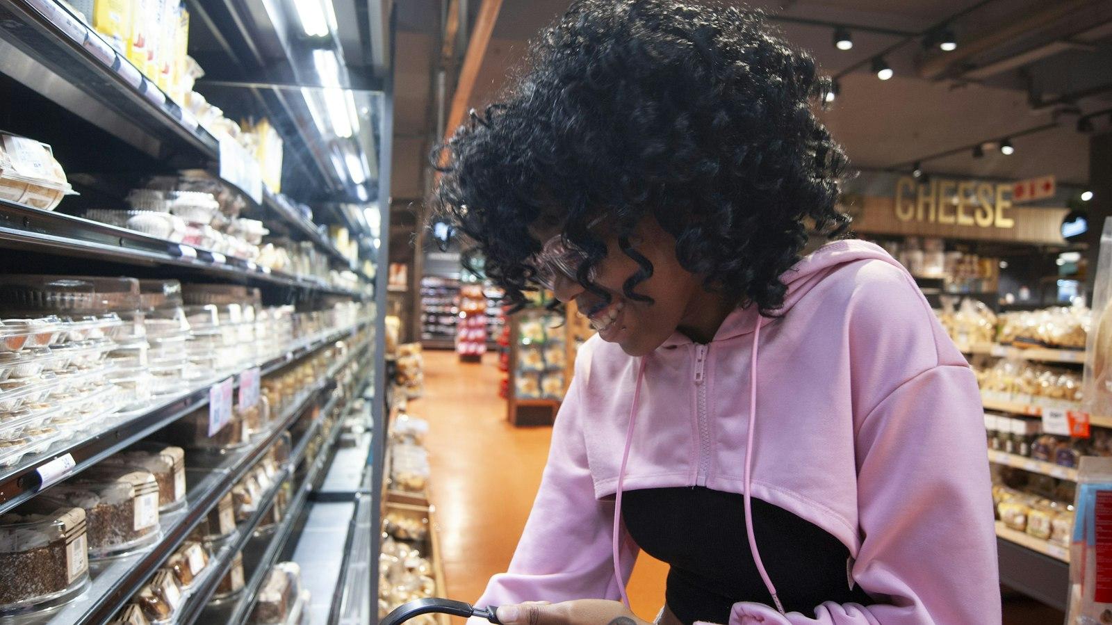 A young shopper browsing a grocery store aisle
