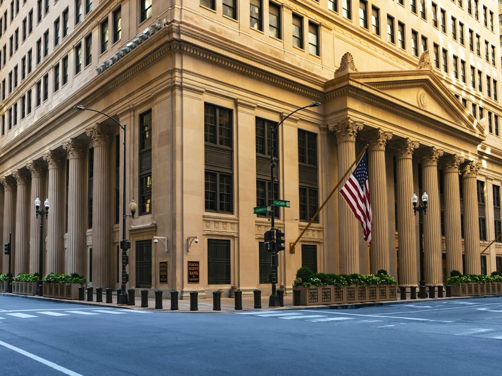 A classical bank building with stone columns on a city corner